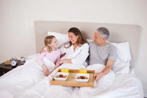 Girl having breakfast with her parents — Stock Photo, Image