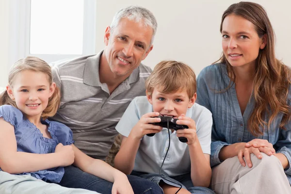 Charmante famille jouant à des jeux vidéo — Photo