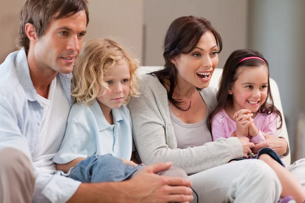 Cheerful family watching television together — Stock Photo, Image