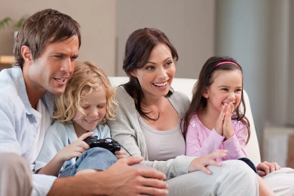 Happy family playing video games together — Stock Photo, Image