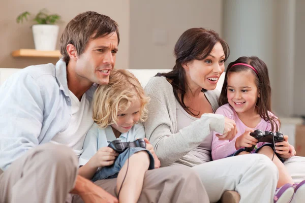 Competitive family playing video games together — Stock Photo, Image