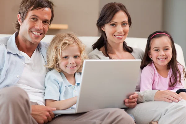 Calm family using a notebook — Stock Photo, Image