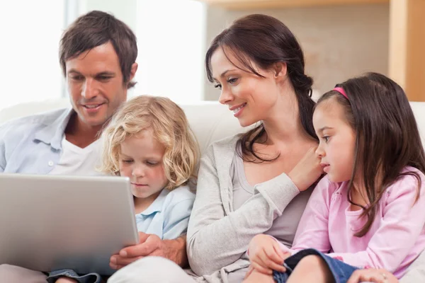 Lugn familj använder en bärbar dator — Stockfoto