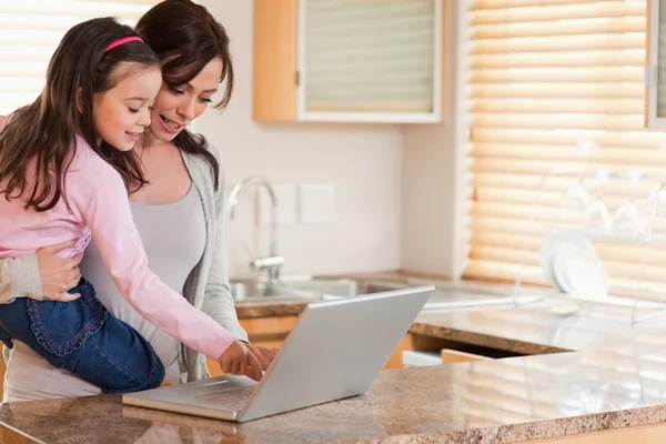Kızı ve annesi bir dizüstü bilgisayar kullanarak — Stok fotoğraf
