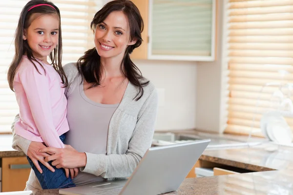 Meisje en haar moeder met behulp van een laptop — Stockfoto