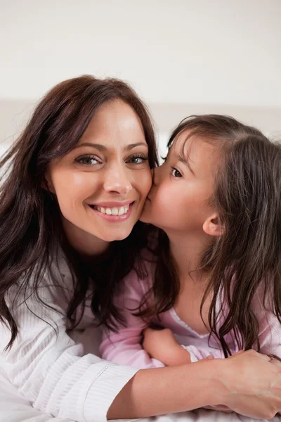 Portrait of a girl kissing her mother — Stock Photo, Image