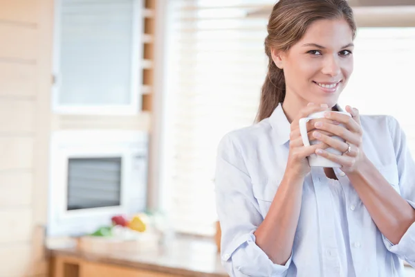 커피를 들고 있는 미소짓는 여자 — 스톡 사진
