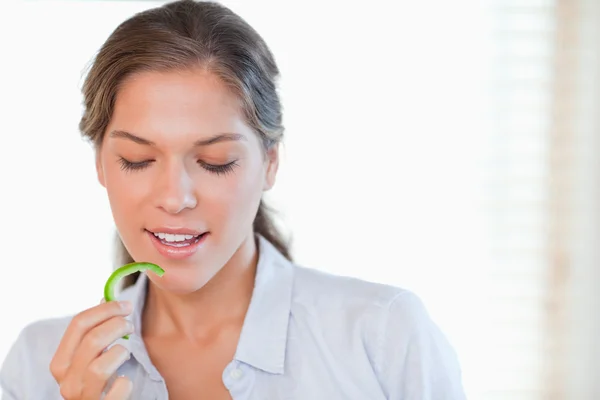 Femme mangeant une tranche de poivre — Photo
