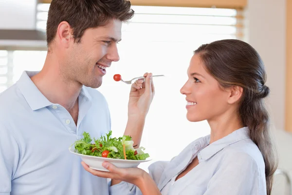 Woman feeding her husband — Stock Photo, Image