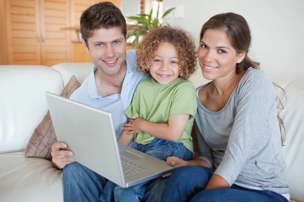 Famille heureuse utilisant un ordinateur portable — Photo