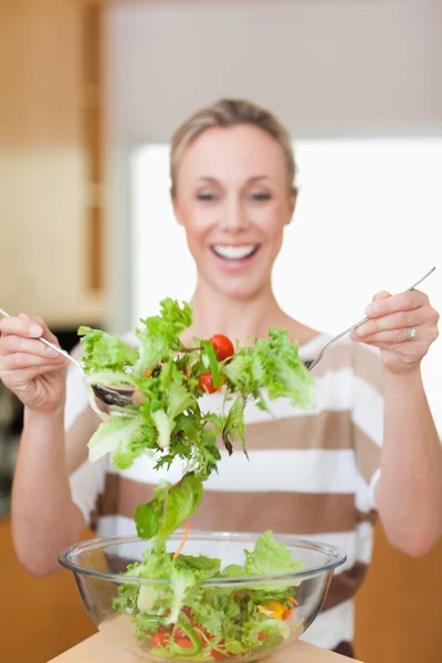 Salad being stirred by woman — Stock Photo, Image