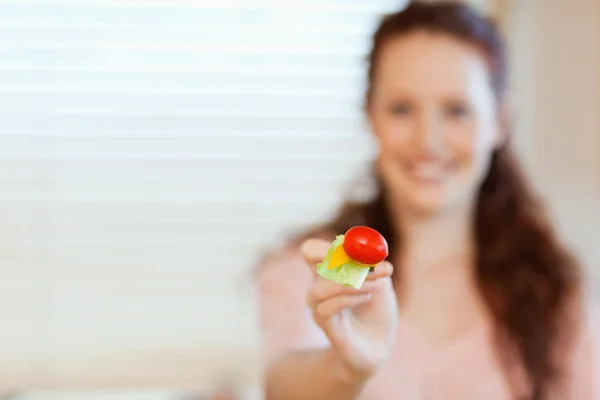 Mouthful of salad being offered by girl — Stock Photo, Image