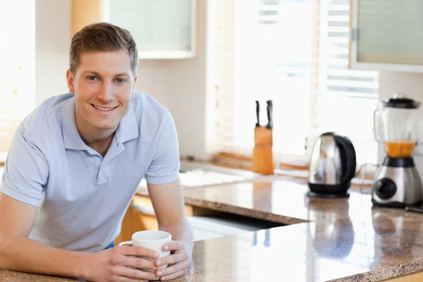 Male leaning against the kitchen counter — Stock Photo, Image