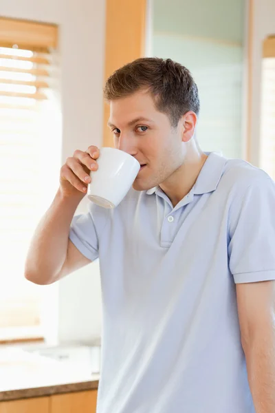 Man drinking some coffee out of his cup — Stock Photo, Image