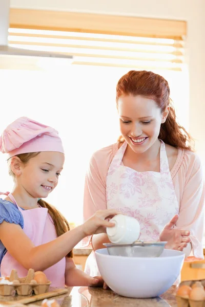 Cheerful mother and daughter preparing dough — Stock Photo, Image