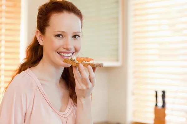 Smiling woman with slice of bread — Stock Photo, Image