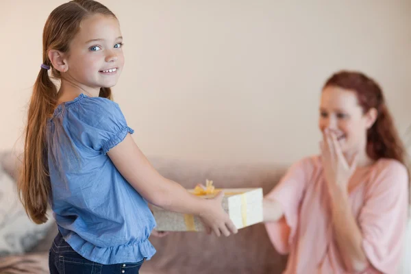 Girl giving her mother a present — Stock Photo, Image