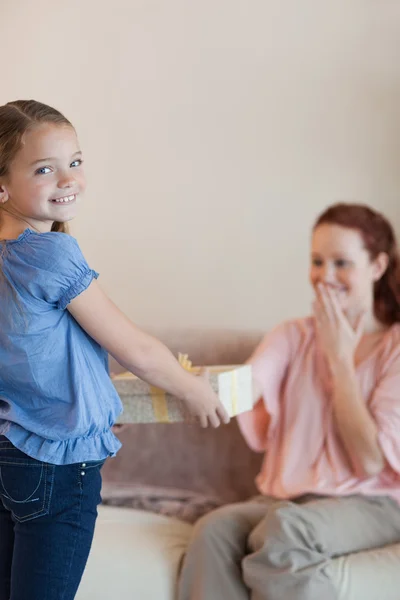 Little girl giving her mother a present — Stock Photo, Image