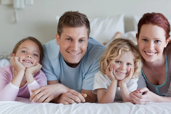 Family lying on the bed — Stock Photo, Image