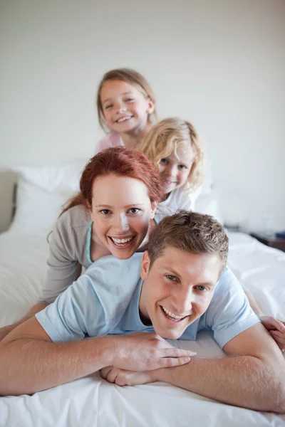 Family having fun on the bed — Stock Photo, Image