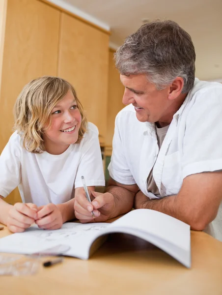 Male helping son with homework — Stock Photo, Image
