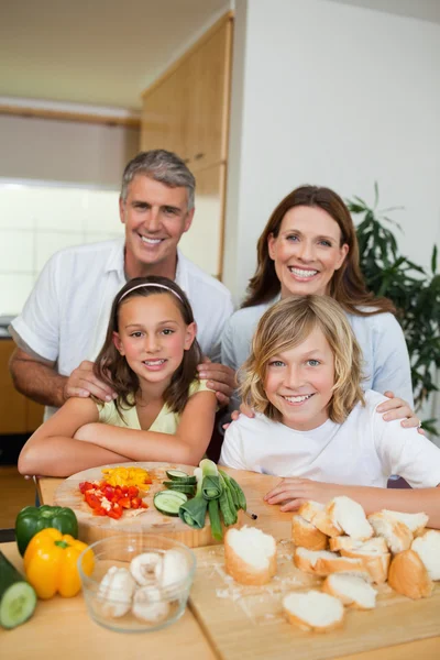 Happy family making sandwiches — Stock Photo, Image