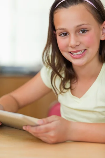 女孩坐在表与平板电脑 — 图库照片