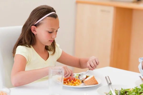Girl having dinner at the table — Stock Photo, Image