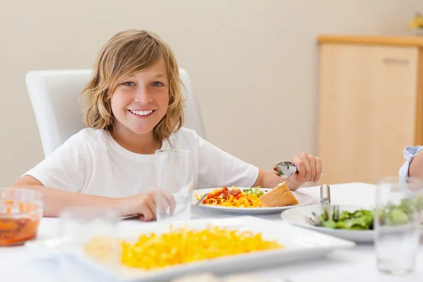 Smiling boy at the dinner table — Stock Photo, Image