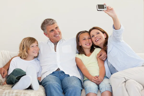 Mother taking a picture on the couch — Stock Photo, Image