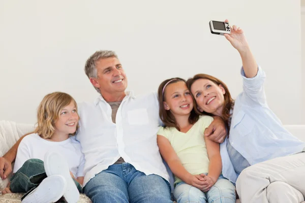 Mother taking a picture on the sofa — Stock Photo, Image