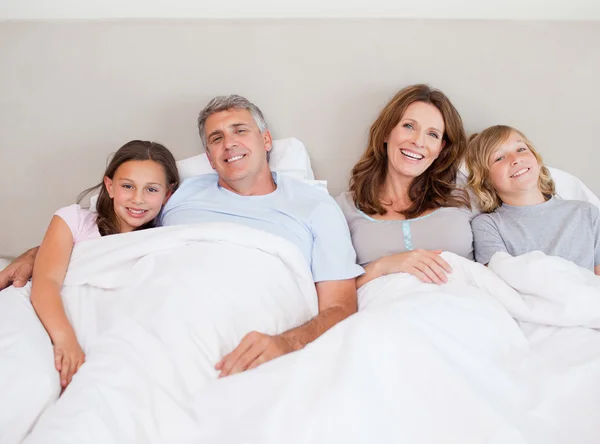 Happy family about to take a nap — Stock Photo, Image