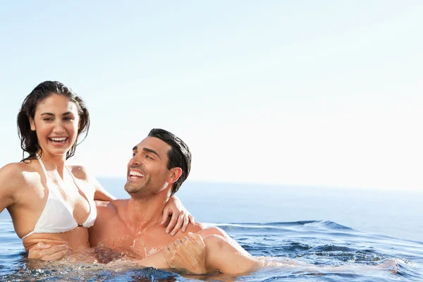 Casal desfrutando de tempo juntos na piscina — Fotografia de Stock