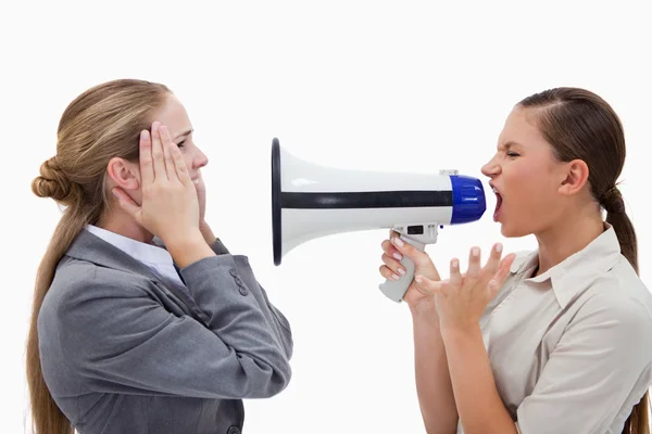 Manager yelling at her employee through a megaphone — Stock Photo, Image