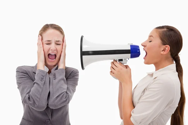 Young manager yelling at her employee through a megaphone — Stock Photo, Image