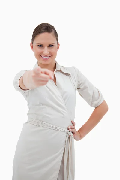 Portrait of a smiling businesswoman pointing at the viewer — Stock Photo, Image