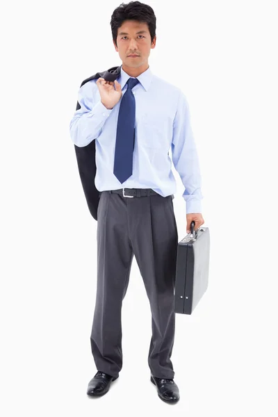 Portrait of a businessman holding a briefcase and his jacket ove — Stock Photo, Image