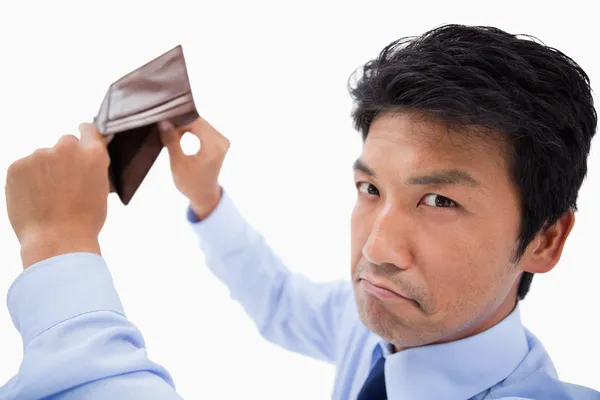 Broke businessman showing his empty wallet — Stock Photo, Image