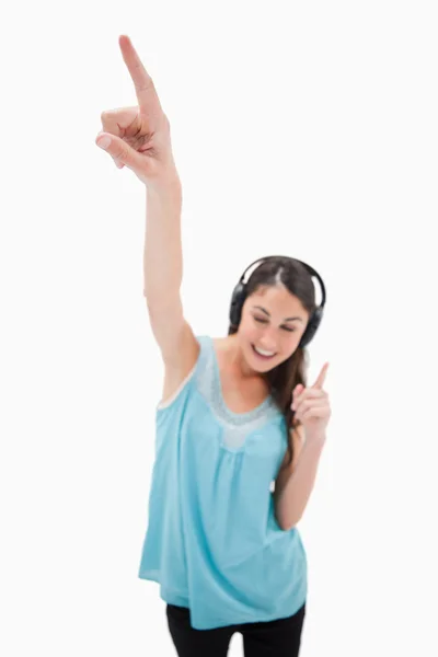 Portrait of a woman dancing while listening to music — Stock Photo, Image