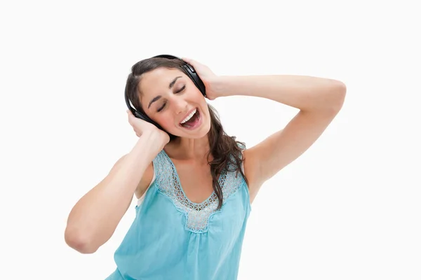 Woman singing while listening to music — Stock Photo, Image