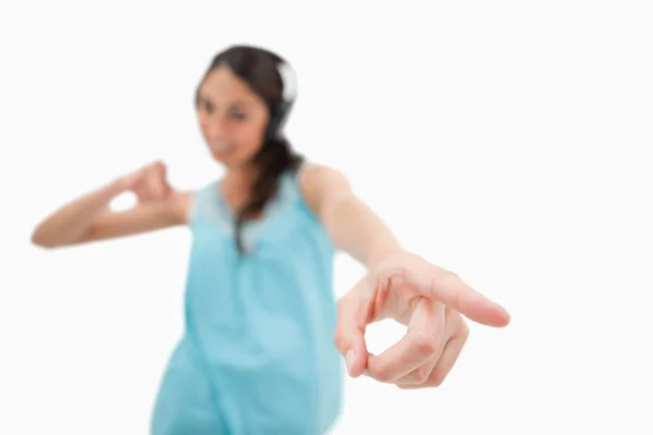 Cheerful woman dancing while listening to music — Stock Photo, Image