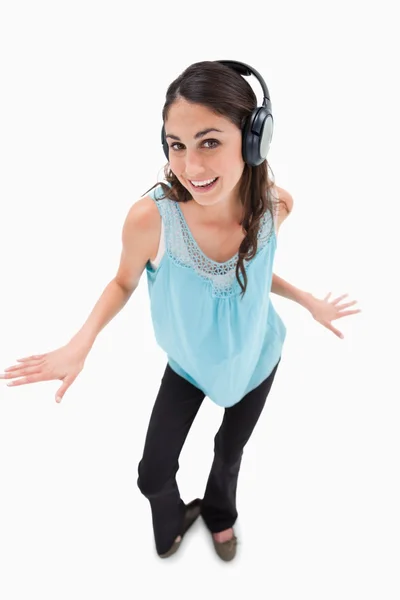Portrait of a cheerful woman dancing while listening to music — Stock Photo, Image