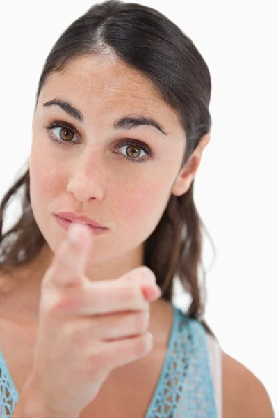 Portrait of a young woman pointing at the viewer — Stock Photo, Image