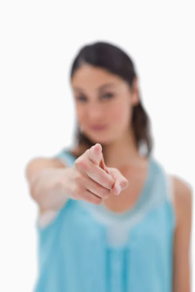 Portrait of a brunette woman pointing at the viewer — Stock Photo, Image