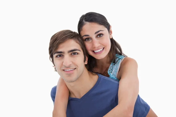 Man holding his girlfriend on his back — Stock Photo, Image