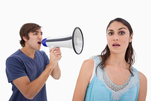 Man yelling at her girlfriend through a megaphone — Stock Photo, Image