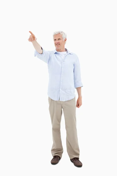 Portrait of a handsome mature man pointing at something — Stock Photo, Image