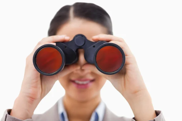 Close up of a businesswoman looking through binoculars — Stock Photo, Image