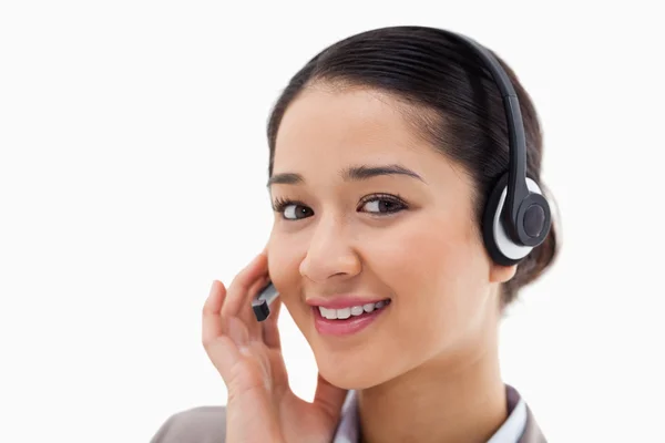 Close up of a smiling operator posing with a headset — Stock Photo, Image