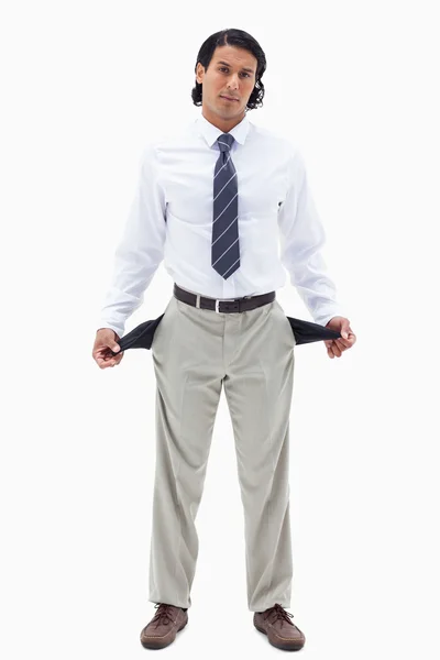 Portrait of a broke businessman showing his empty pockets — Stock Photo, Image